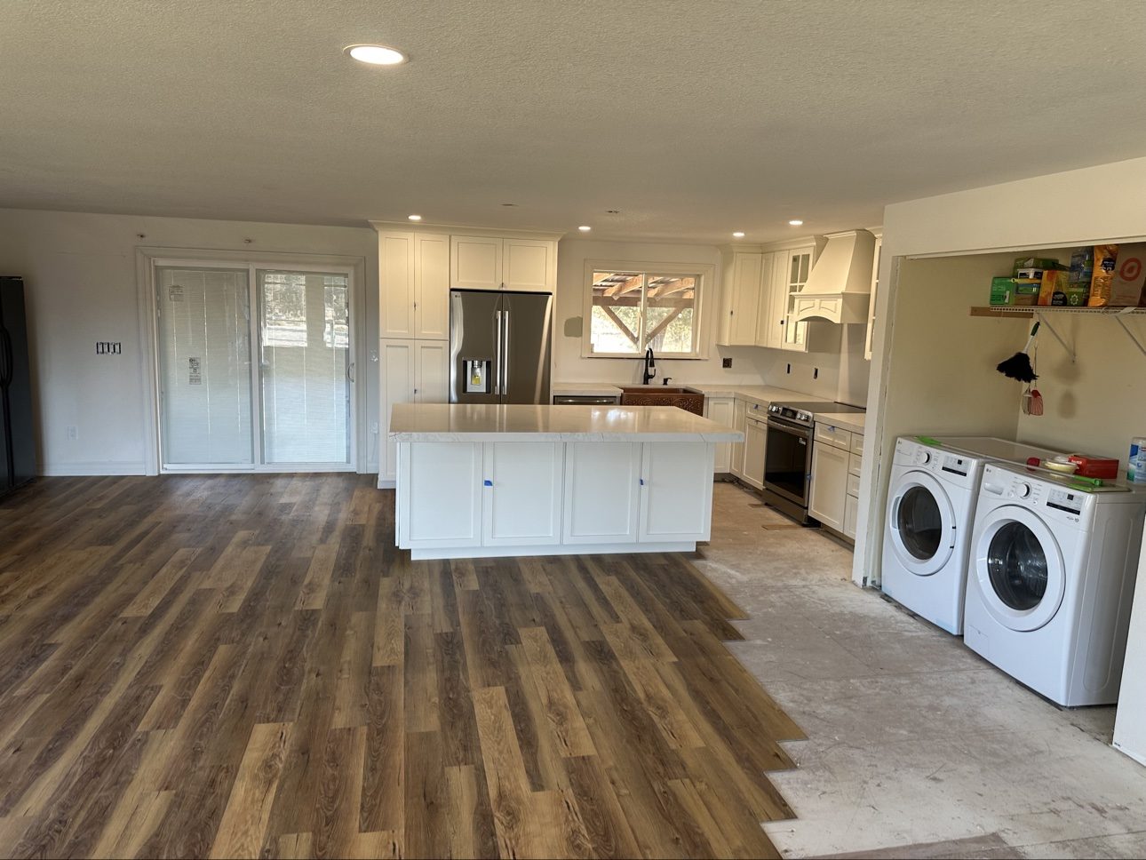 Finished kitchen with white shaker cabinets and copper farmhouse sink